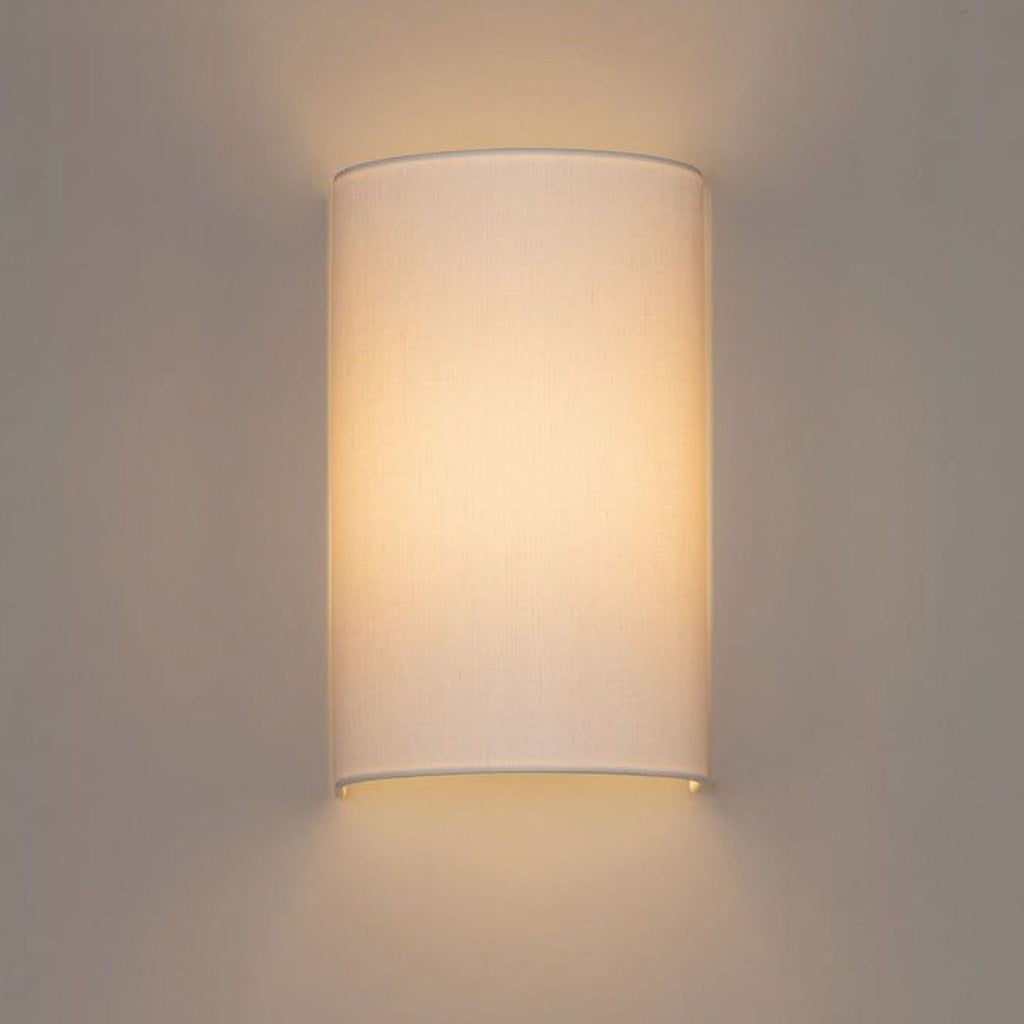 1. Santa & Cole wall sconce with a curved white linen shade, offering soft, diffused lighting and an elegant appearance.