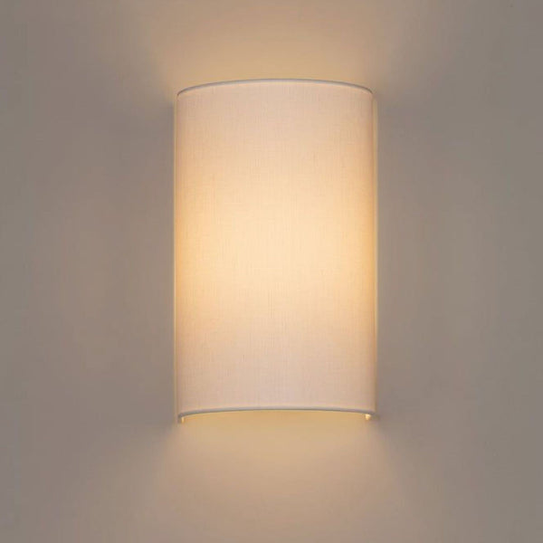 1. Santa & Cole wall sconce with a curved white linen shade, offering soft, diffused lighting and an elegant appearance.