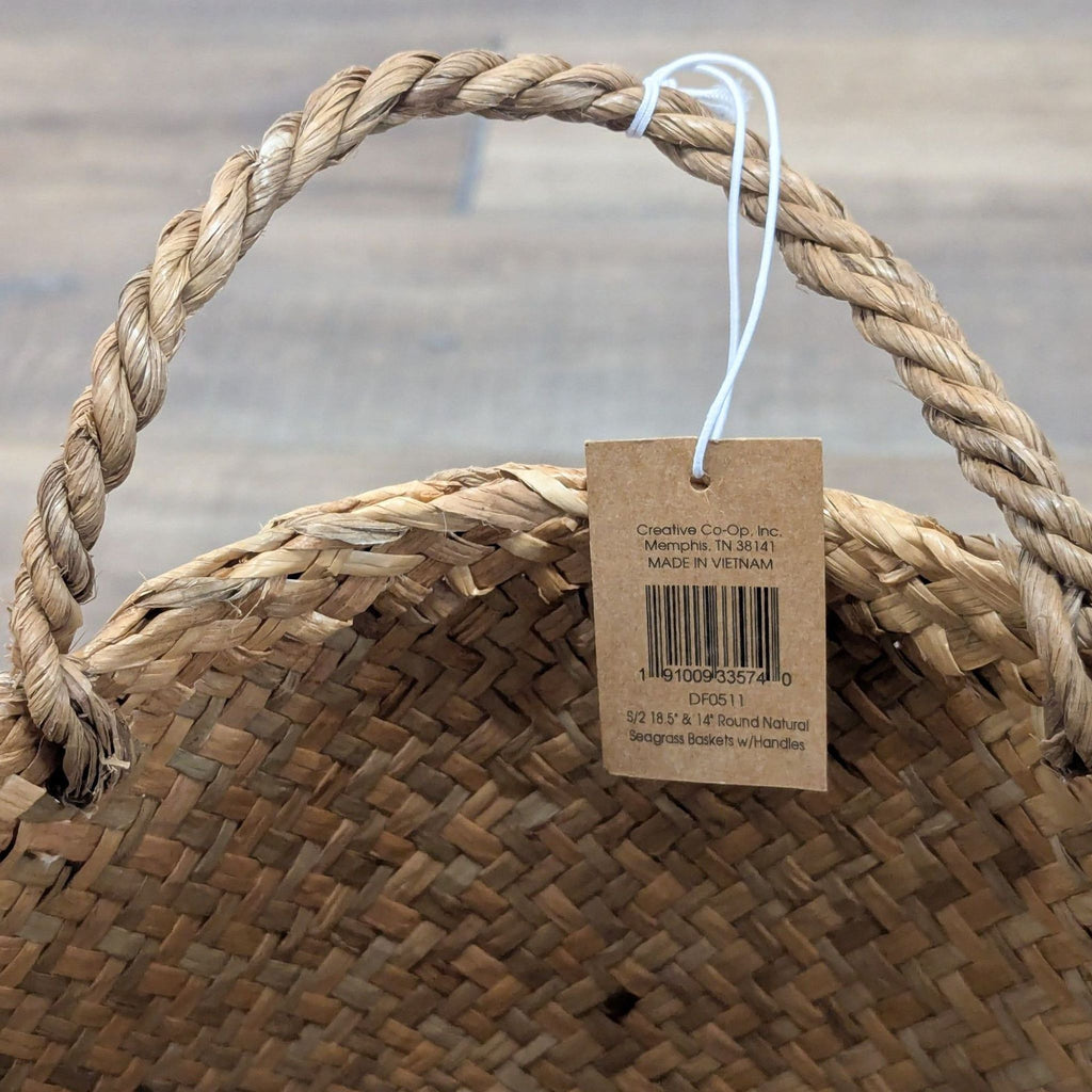 Close-up of a woven seagrass basket handle with a Creative Co-Op brand tag attached.  