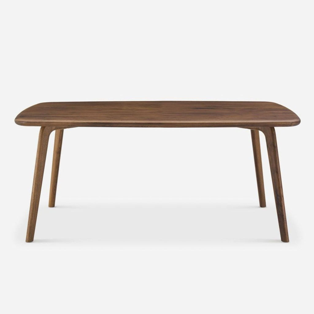 1. Castlery solid American walnut dining table with rounded rectangular top and angled legs, viewed from the front.