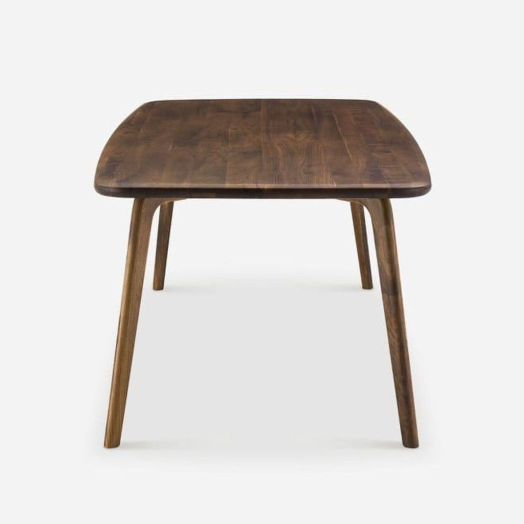 3. Front-facing view of a Castlery dining table crafted in solid American walnut, showcasing its elegant simplicity.