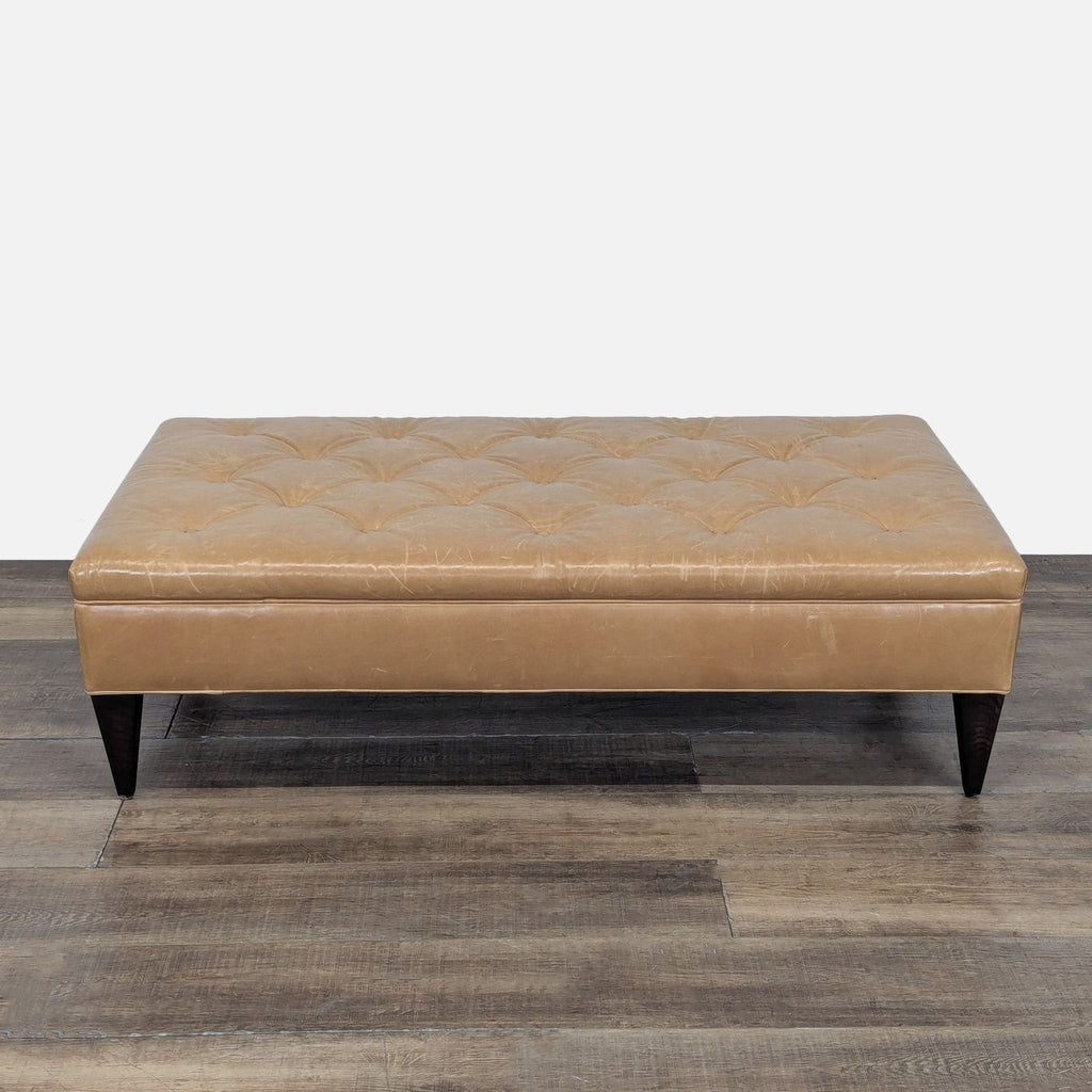 2. West Elm tan tufted leather bench ottoman on tapered dark legs, shown from above on rustic flooring.