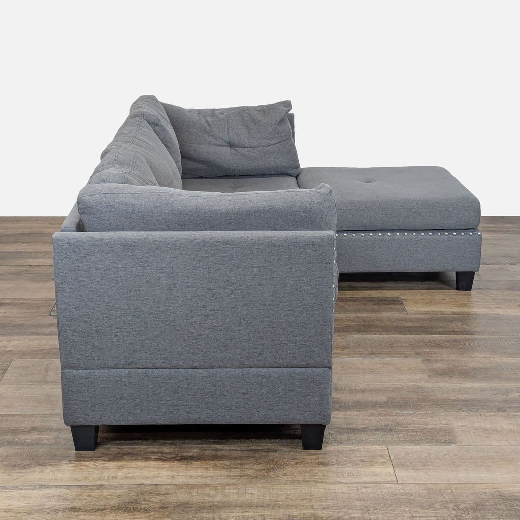 3. Amazon sectional in gray fabric, viewed from the end, highlighting stuffed trim and flexible chaise design.