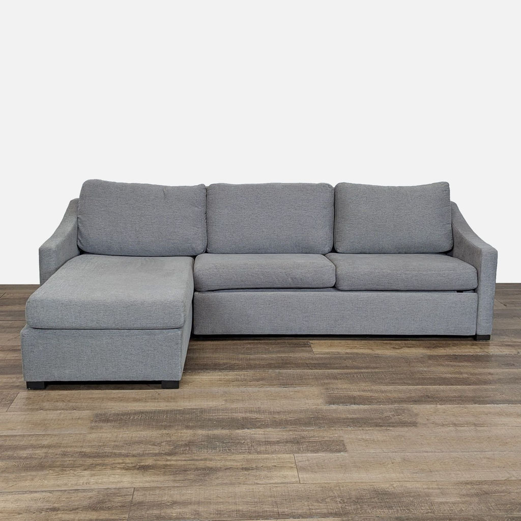 1. Modern grey sectional sofa with slope arms and chaise, by Crate & Barrel, shown on wood flooring.