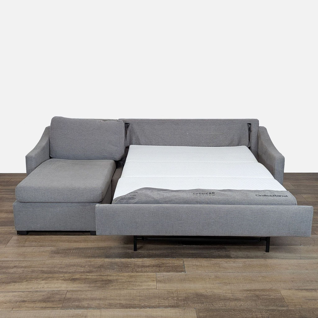 2. Crate & Barrel sectional sleeper sofa extended, revealing a gel top mattress and Tiffany 24/7 Sleep System.