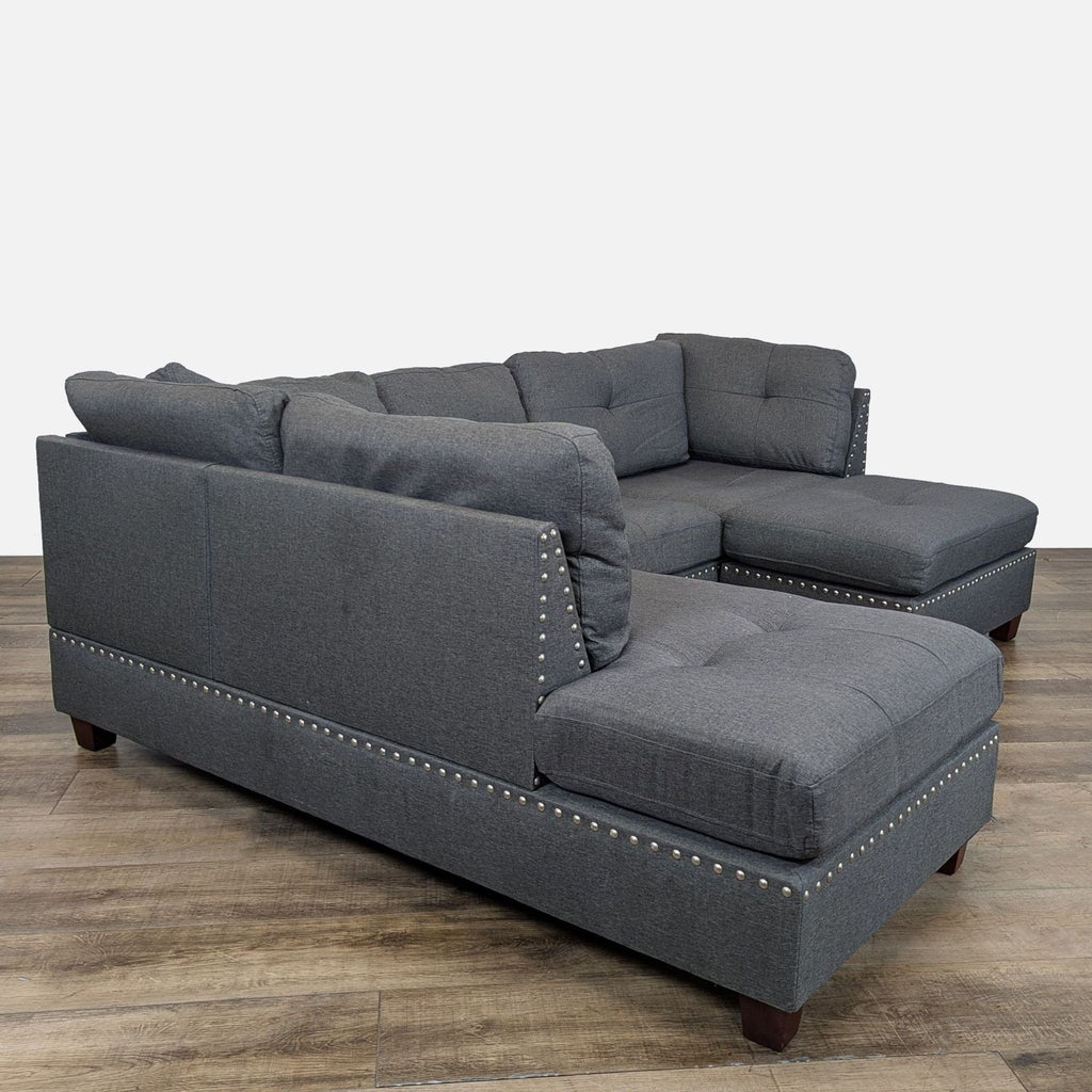 2. Side view of Amazon sectional sofa in gray fabric, featuring studded accents and plush cushions.