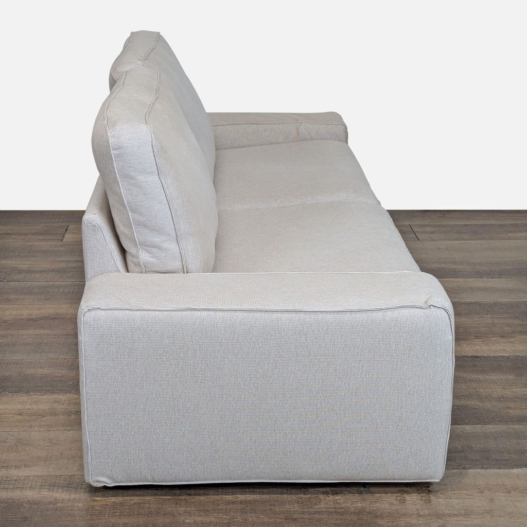 2. Side angle of an Ikea 3-seat sofa, highlighting its generous seating, low arms, and plush cushions.