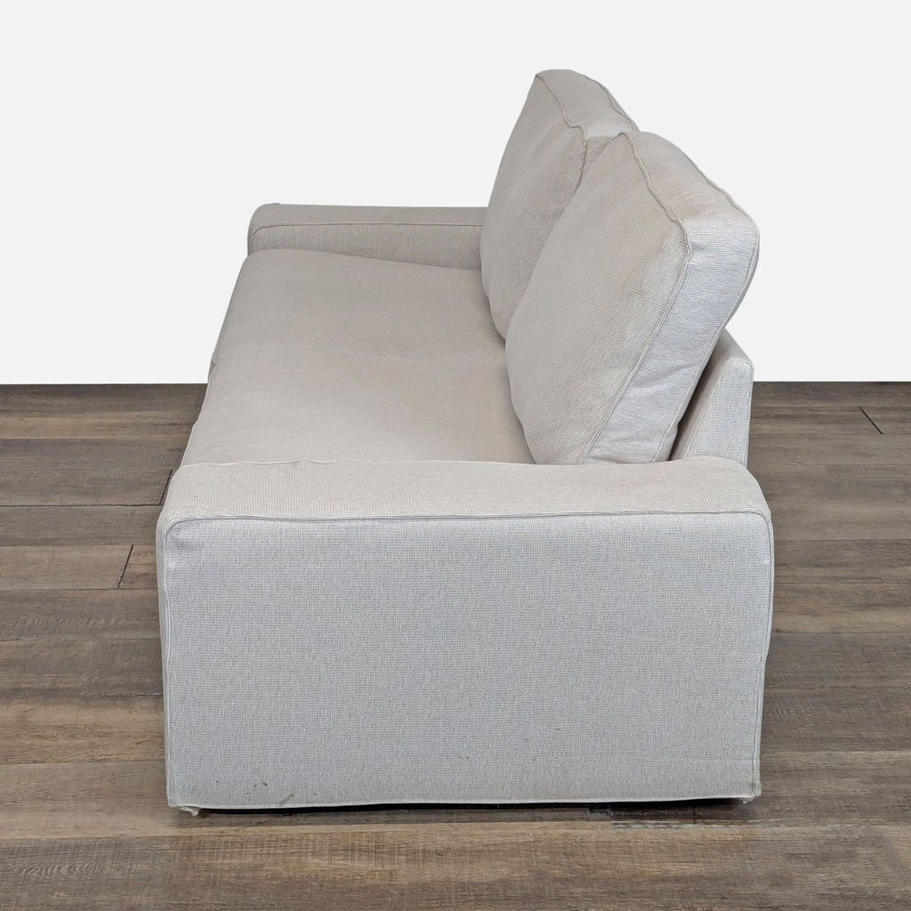 3. Ikea 3-seater sofa from a side view, showing wide seat, supportive cushions, and comfortable low armrests.