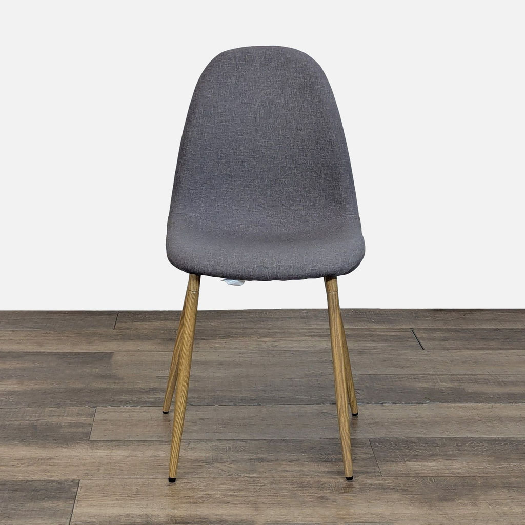 1. Front view of a Reperch dining chair with a curved grey fabric seat and wooden legs on a wooden floor.