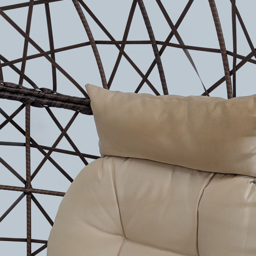3. Close-up of plush, beige cushion and woven rattan-style frame of the Reperch egg chair.
