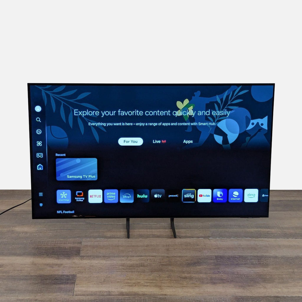 Samsung OLED 4K Smart TV displaying its Smart Hub interface, with streaming app icons and colorful background art.  