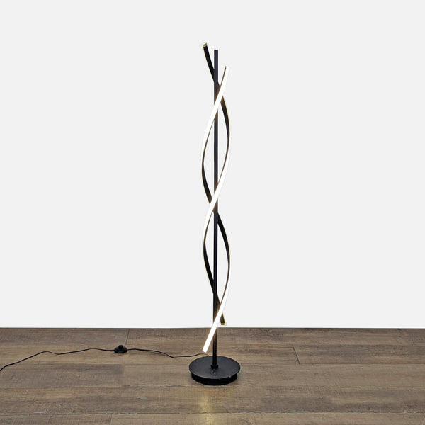 Black metal spiral floor lamp with LED light, standing on a wooden floor, from Reperch Lighting.  