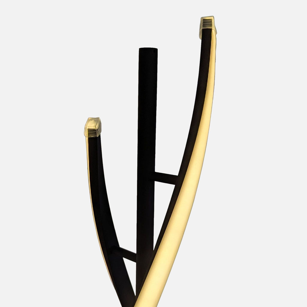 Close-up of the upper spiral LED arms of a black metal Reperch floor lamp in a modern design.  