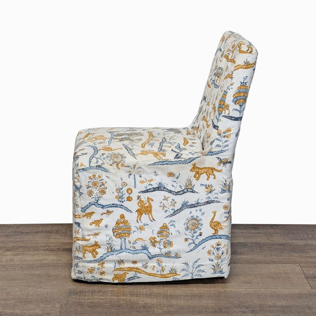 3. Restoration Hardware slip covered chair with blue and gold print, shown from the opposite side angle.