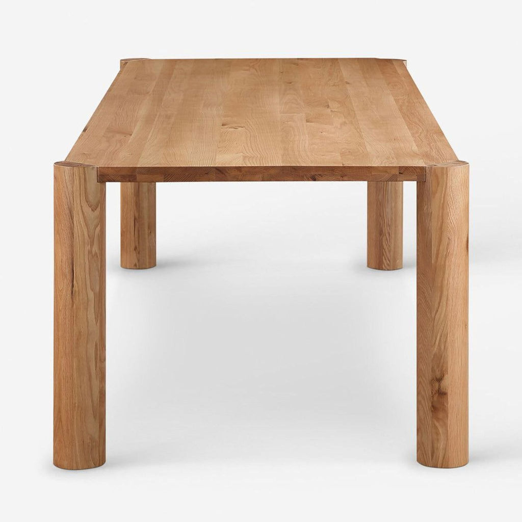 Side angle showing the Lulu and Georgia oak dining table, featuring modular posts for adjusting each corner leg’s position.