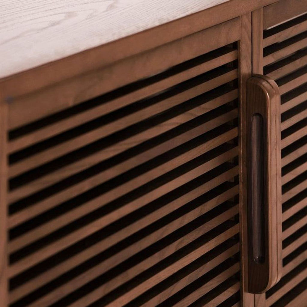 3. Close-up of ash veneer slatted accordion door and handle on Burrow entertainment center for audio clarity.