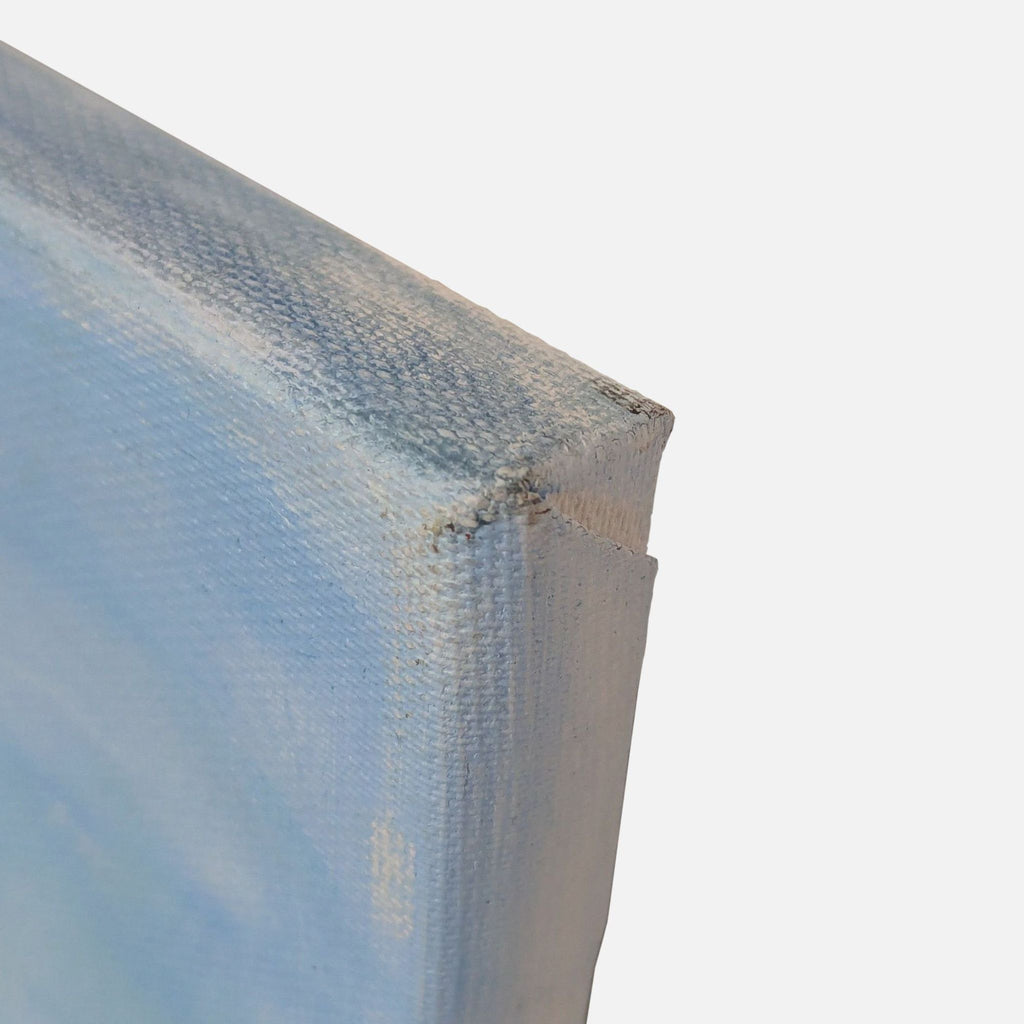 3. Edge detail of a painted canvas, highlighting blue acrylic or oil paint and the texture of the surface.