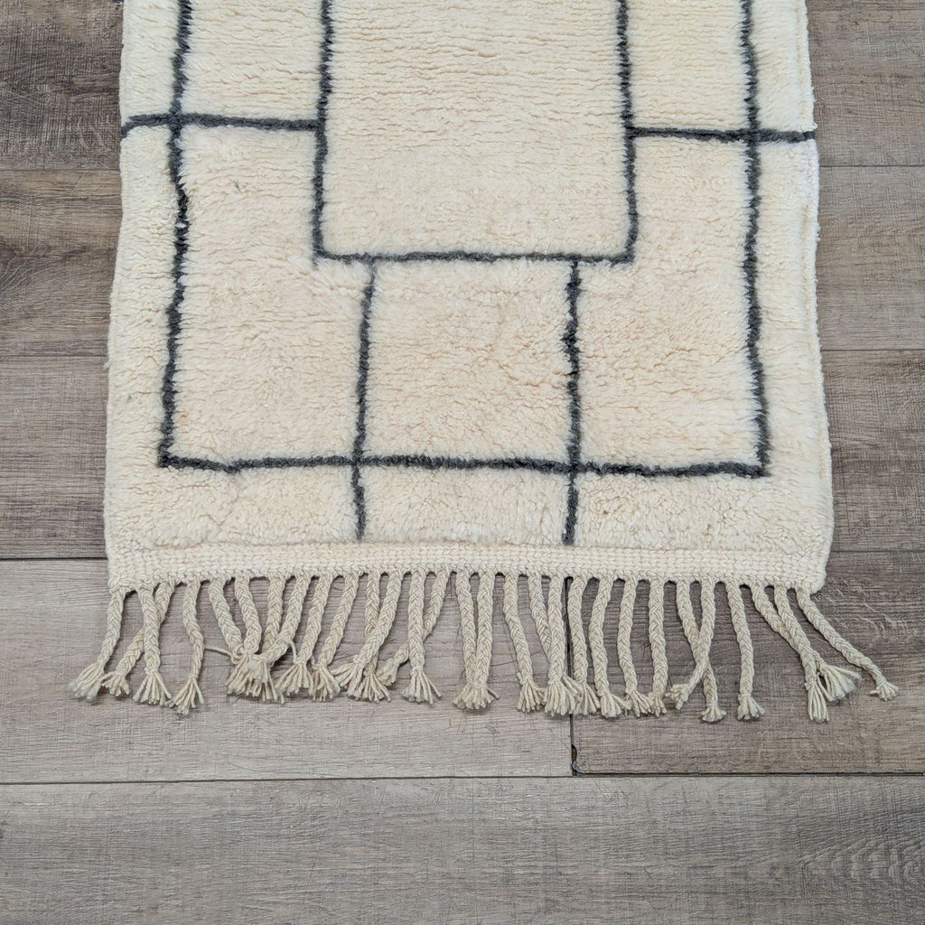 2. Close-up of a Beni Ourain rug showing detailed knotted patterns and natural wool fibers with tassels.  