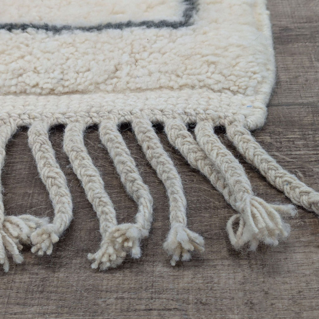 3. Detailed view of thick, twisted fringed ends on a Moroccan hand-knotted wool Beni Ourain rug.