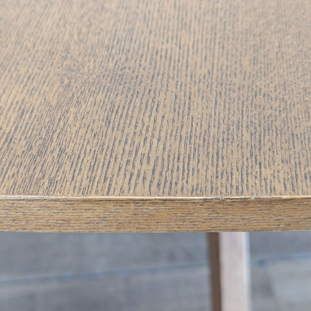 3. Detailed edge of the dining table top, highlighting the walnut veneer and visible wood grain design.