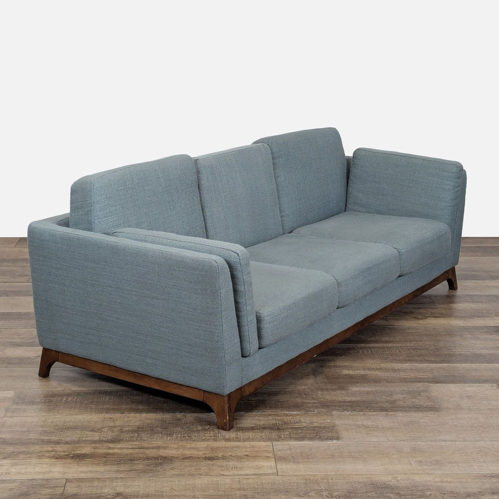3. Angled perspective of the Article 3-seat sofa, highlighting its loose cushions and solid wood base.