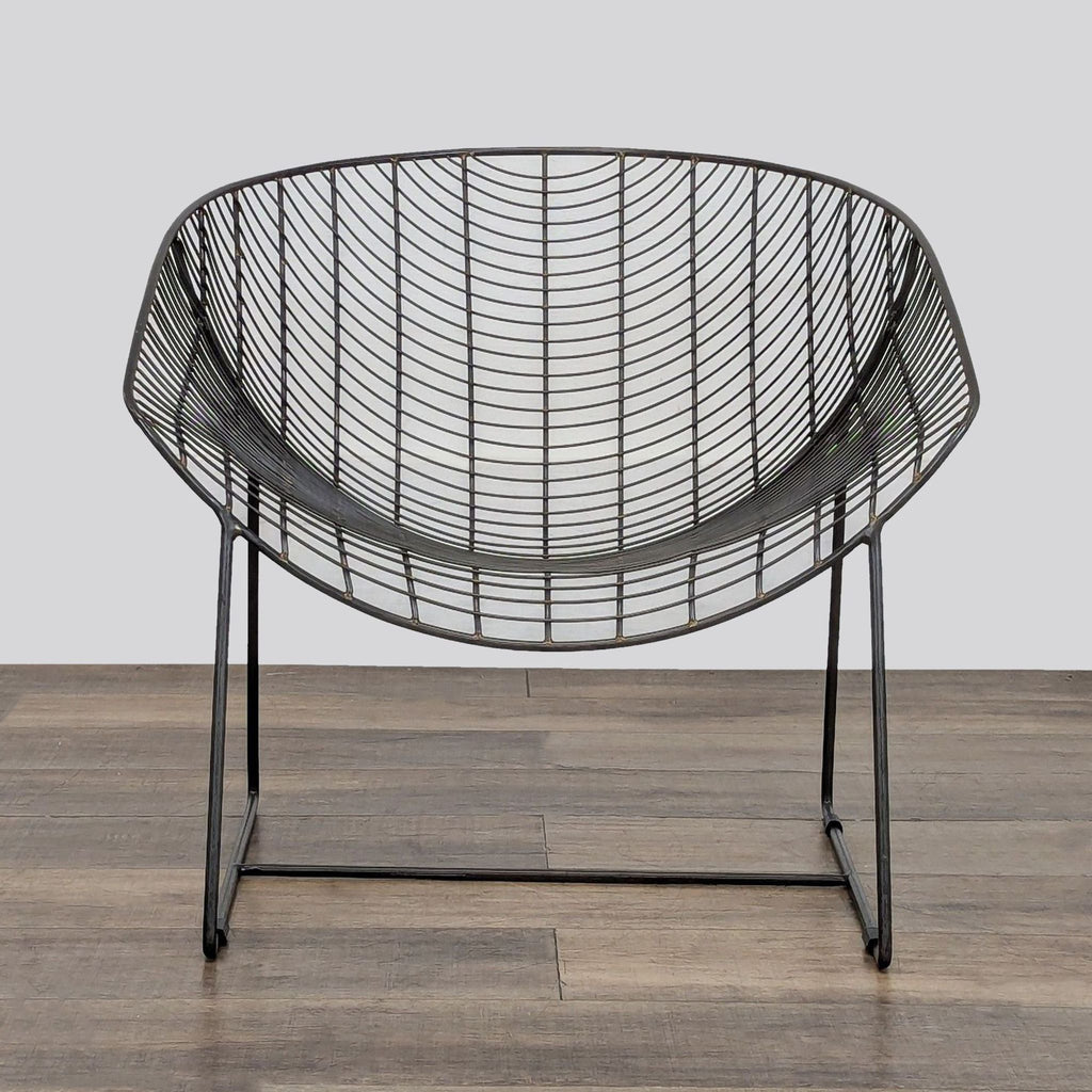1. Modern lounge chair handcrafted from powdercoated iron, featuring a wide wire design and protective glides.