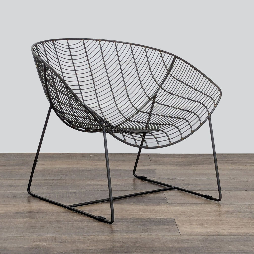 3. Sleek lounge chair in powdercoated iron with scooped seat, sturdy base, and protective glides, by CB2.