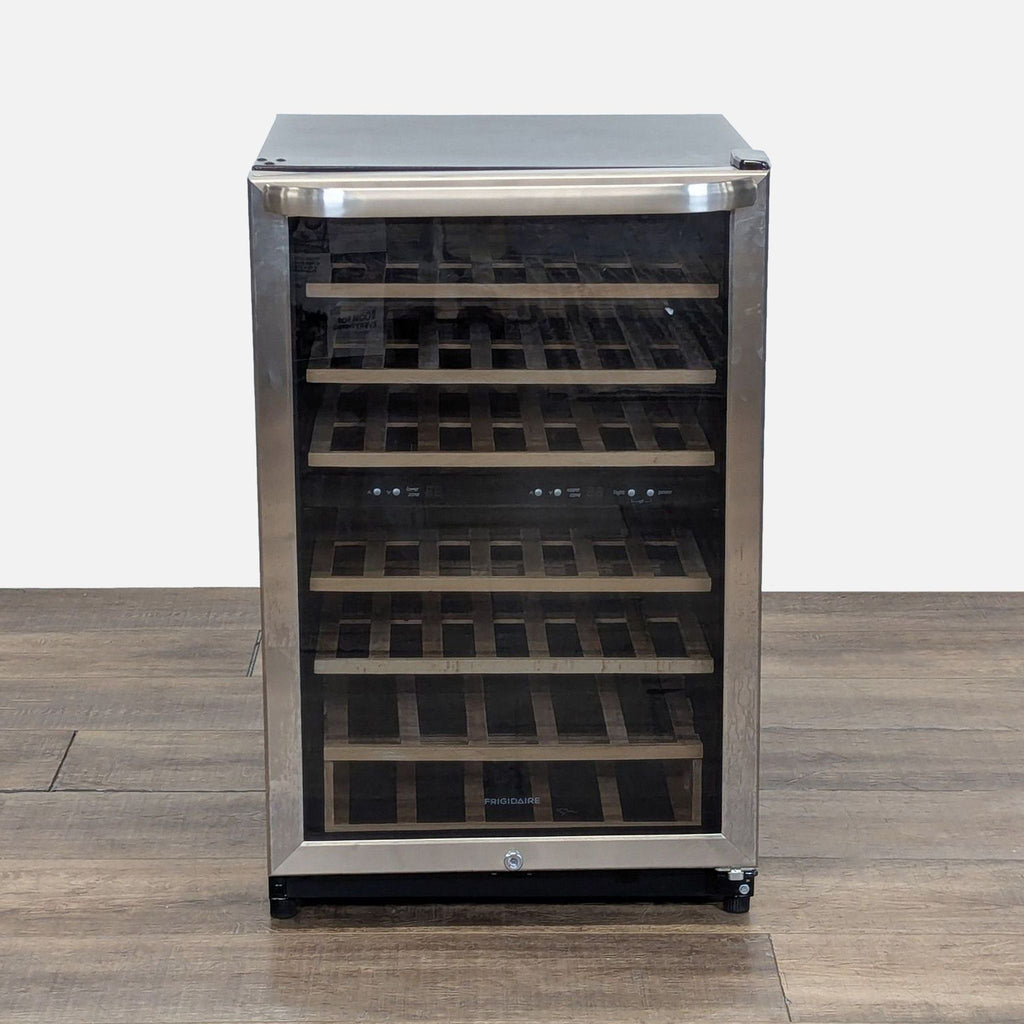 2. Front view of a Frigidaire wine cooler with stainless steel trim, glass window, and wooden shelves inside.