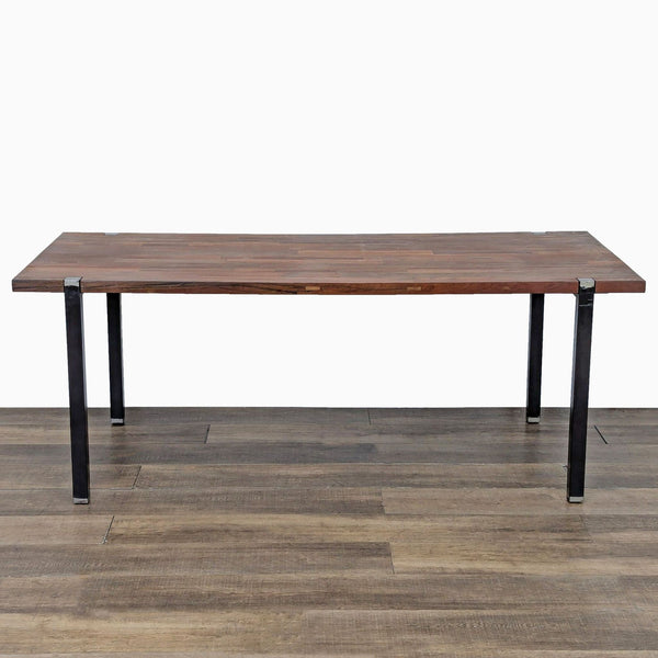 1. CB2 dining table with a rectangular wooden top and black metal legs, set on wood flooring.