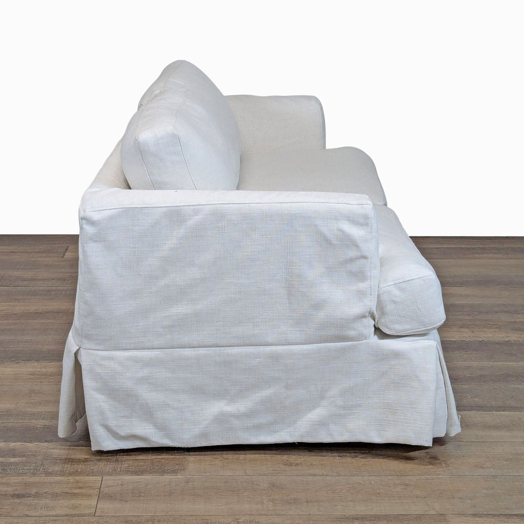 2. Side view of Joss & Main 3-seat sofa featuring a tailored skirt and plush, down-filled slipcover cushions.