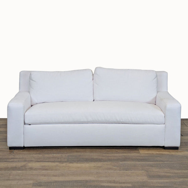1. Front view of a white Restoration Hardware sleeper sofa with fabric upholstery and track arms on wood floor.