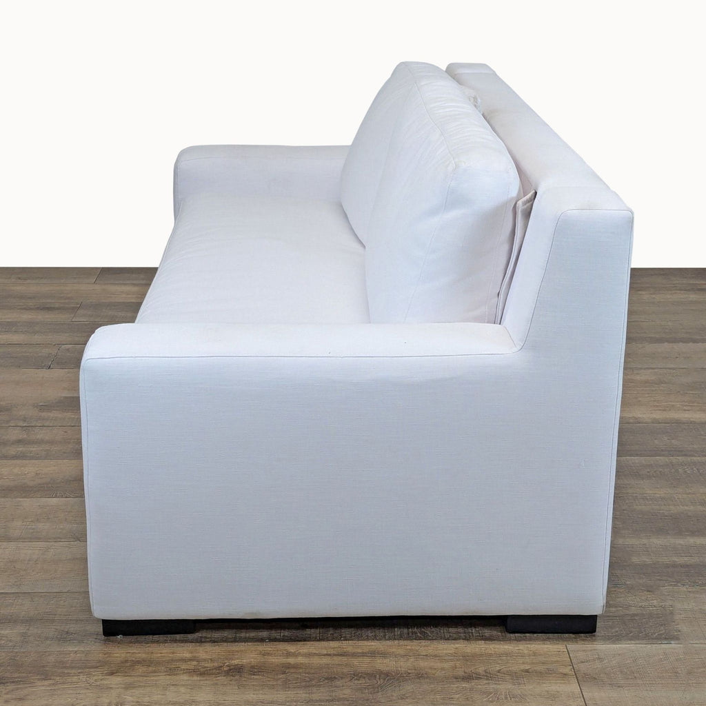 3. Side view showing track arm and fabric upholstery on a white Restoration Hardware sleeper sofa.