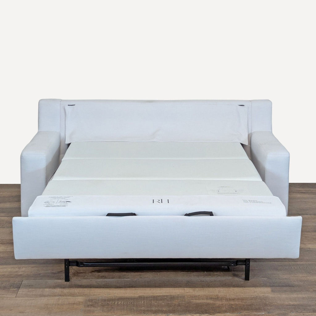 2. Restoration Hardware sleeper sofa with pull-out American Leather Gel Mattress fully extended on wood floor.