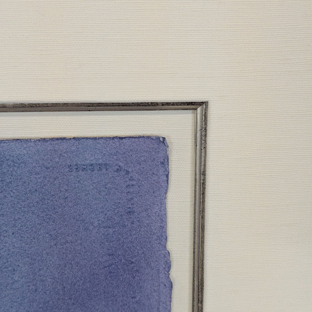 3. Detailed view of the white gold gilded custom frame's corner and textured watercolor paper edge.