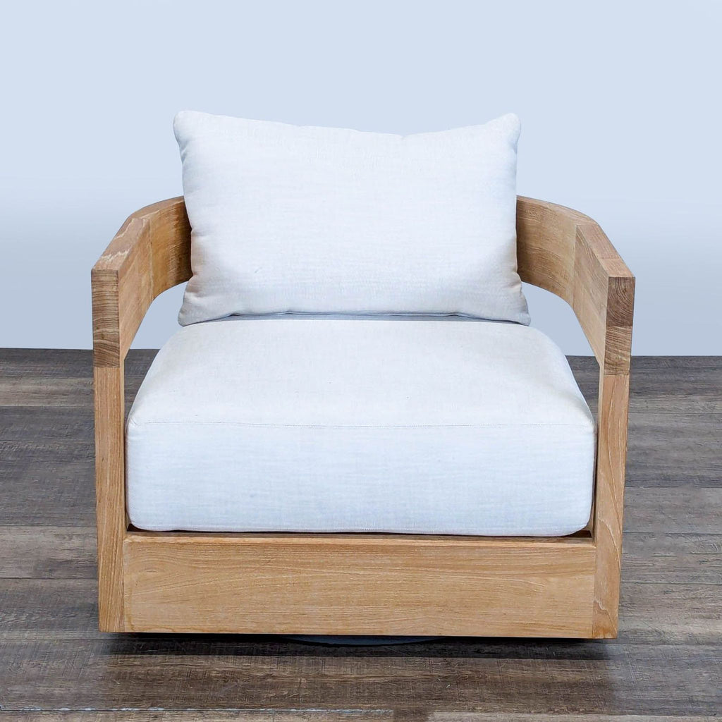 1. Front view of Restoration Hardware Balmain chair with curved solid teak frame and white cushions on wooden floor.