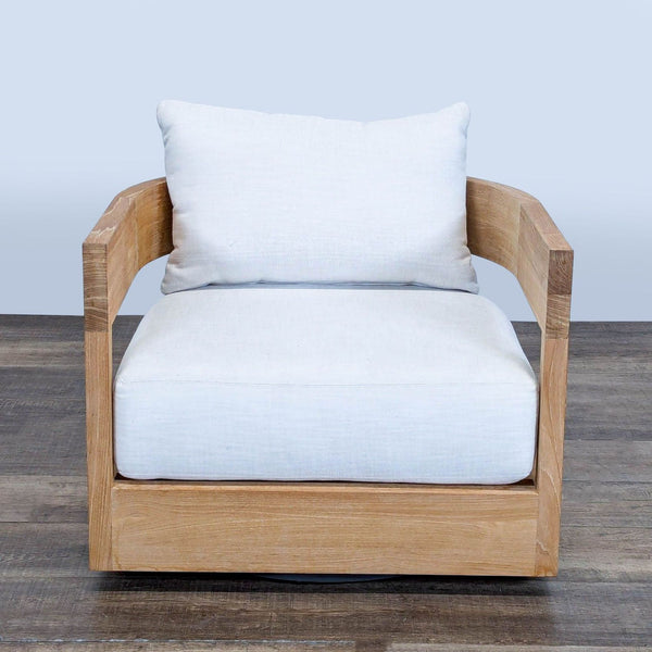 1. Front view of Restoration Hardware Balmain chair with curved solid teak frame and white cushions on wooden floor.