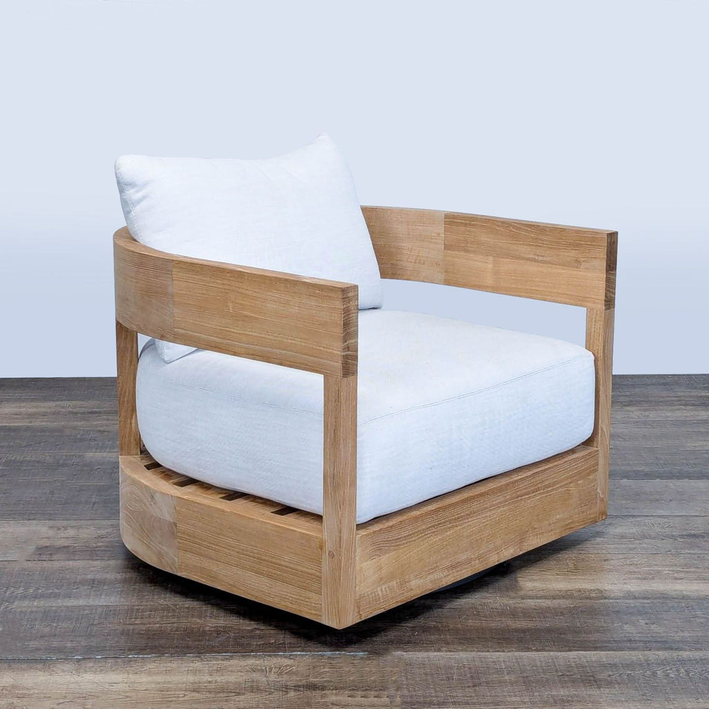 3. Angled perspective of Restoration Hardware's Balmain chair, highlighting its iconic arch-inspired design and solid teak build.