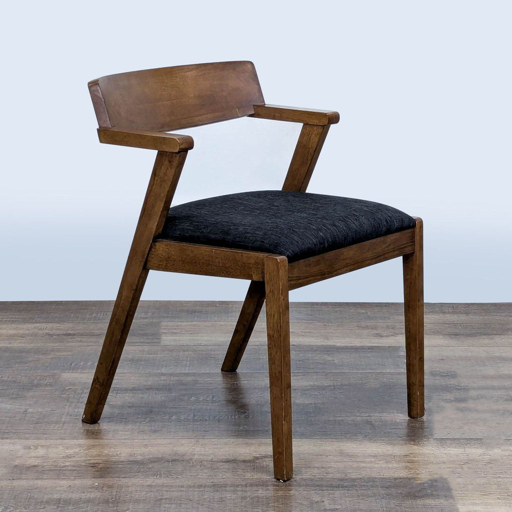 3. Angled view of Article Zola dining chair, showing wood frame and black foam seat, modern armrest design.