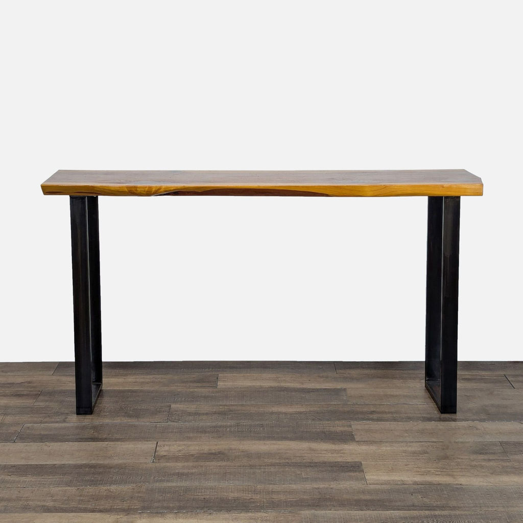 2. Console table by Reperch featuring metal sled legs and a natural wood slab top, perfect for hallways.