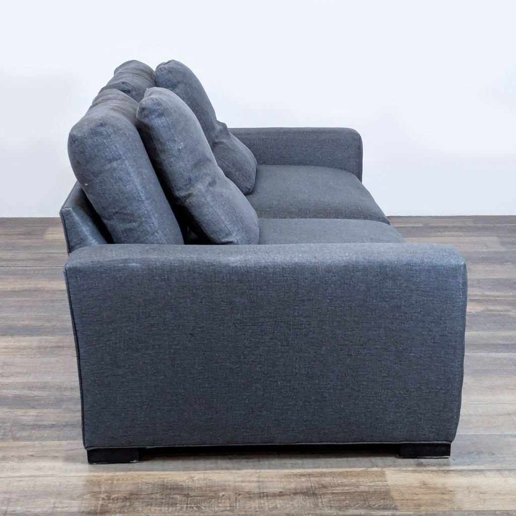 2. Side angle showing the armrest and cushioned back of the Room & Board Metro 3-seat sofa.  