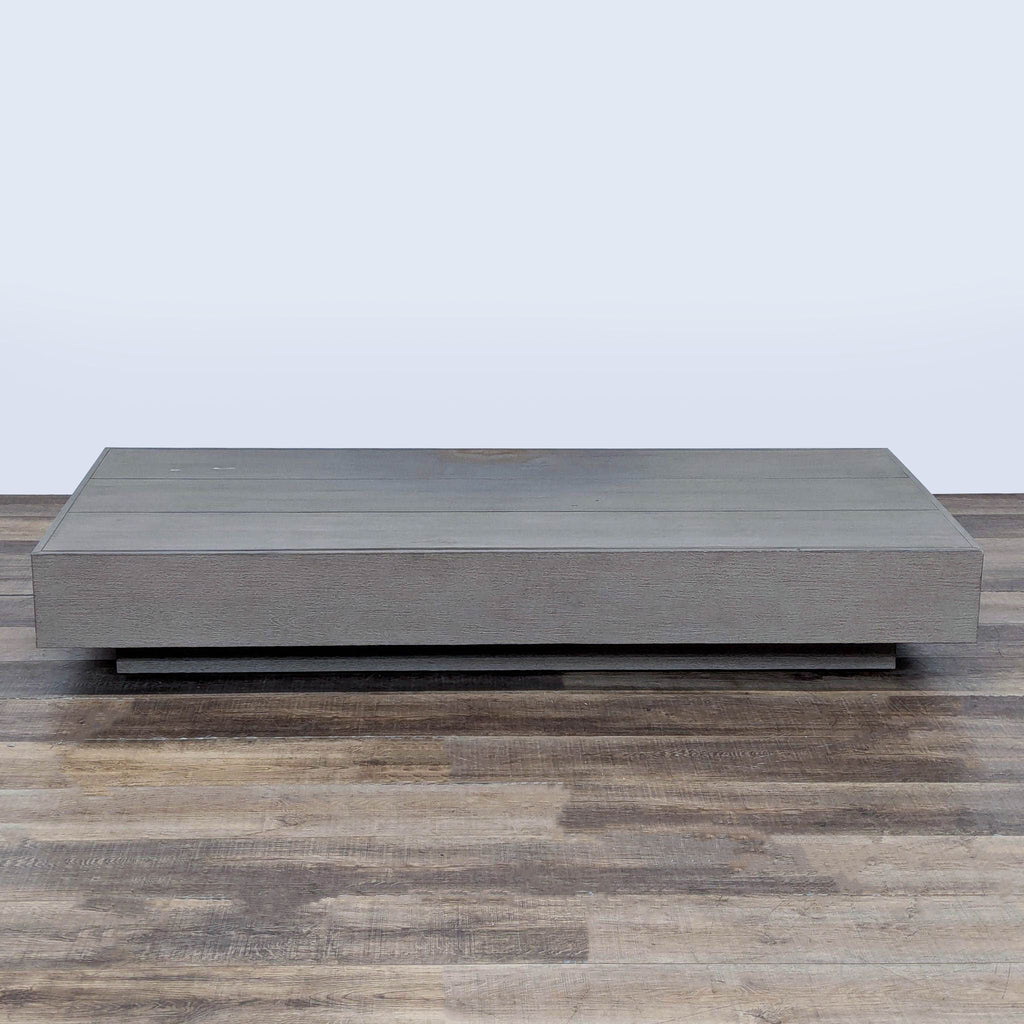 3. Solid teak coffee table by Restoration Hardware with a weathered look, rectangular shape, and minimal base.