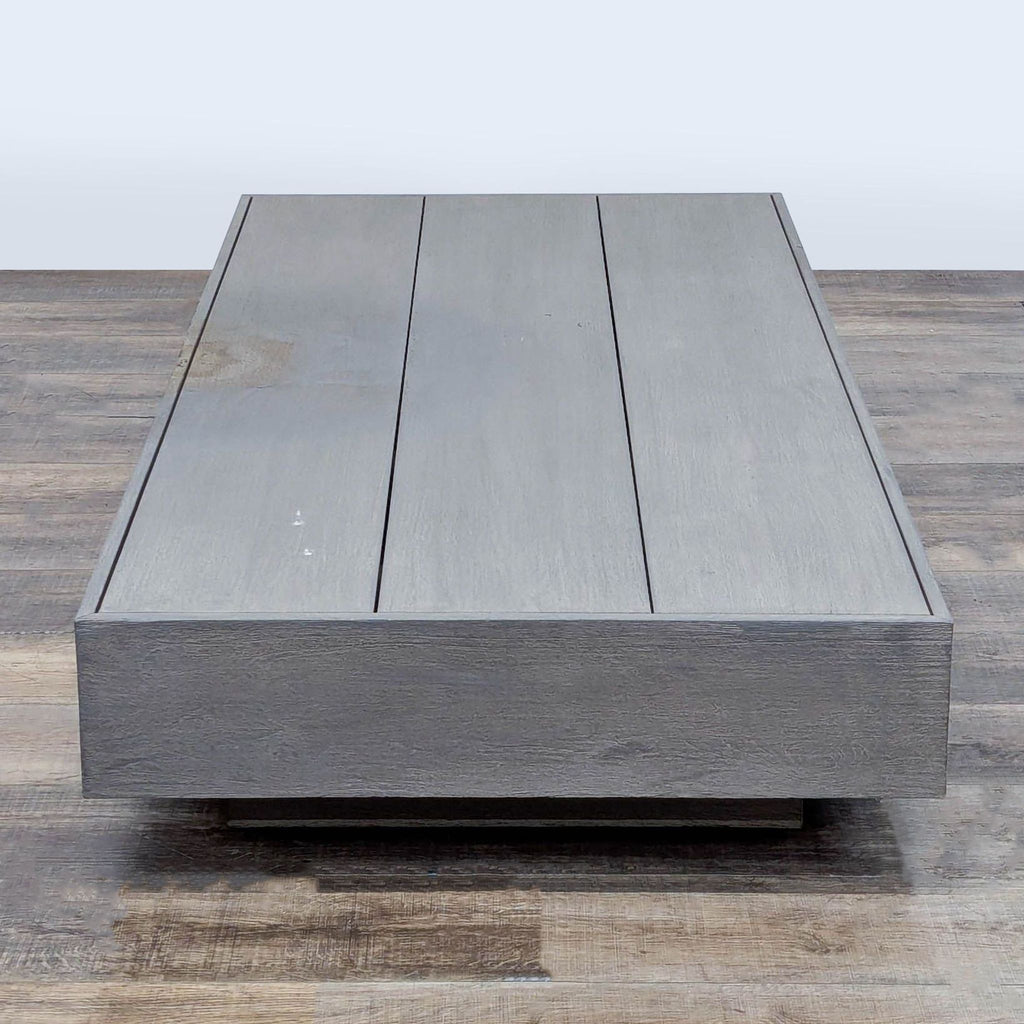 2. Modern, low-profile teak table by Restoration Hardware, featuring a weathered finish and plank-style top.  