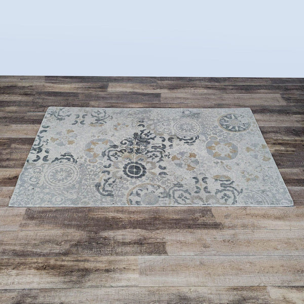 1. Pottery Barn rug with a vintage-inspired pattern, displayed on a wood floor. Soft neutral and blue tones.