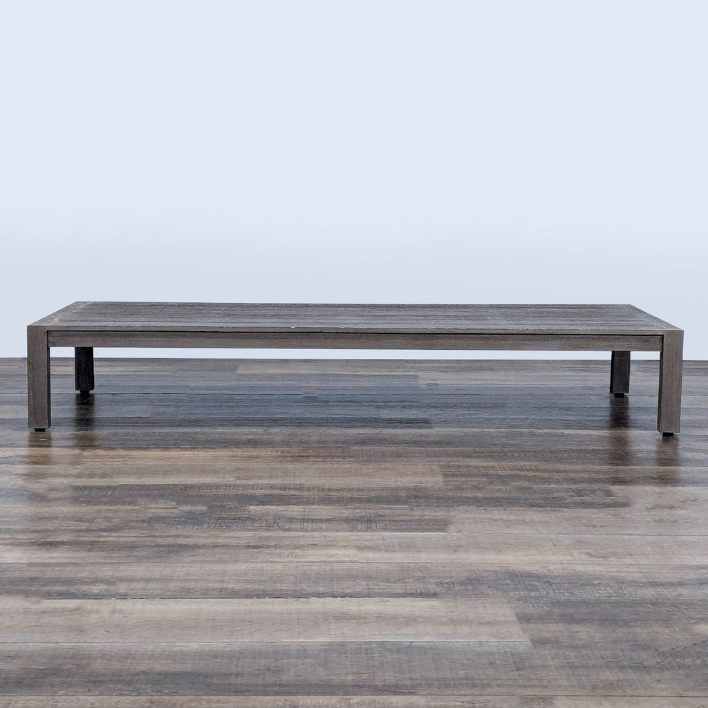 1. Rectangular weathered teak table with a plank top by Restoration Hardware, set on a wooden floor.