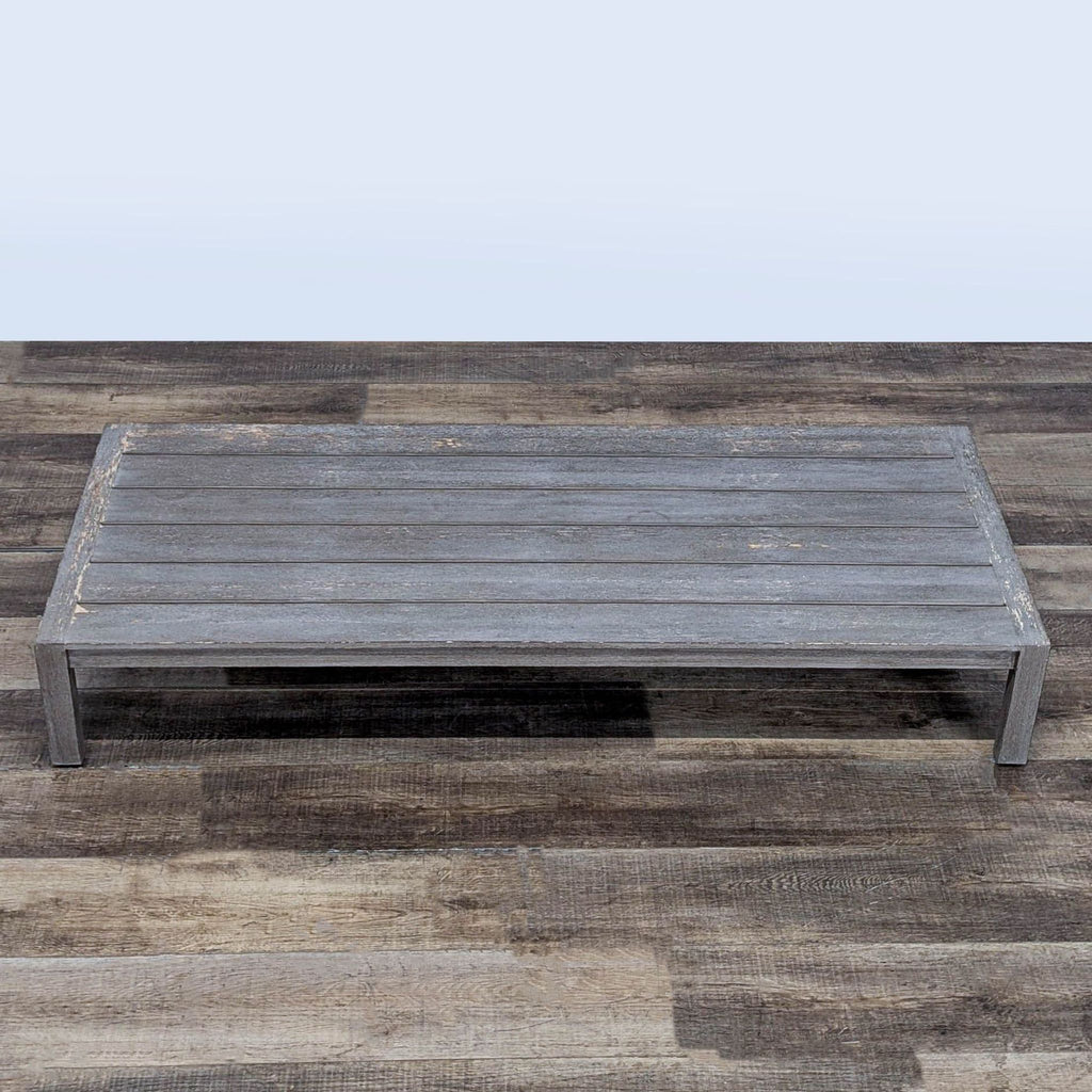 2. Overhead view of a Restoration Hardware solid teak plank-top table showing its rustic, weathered finish.