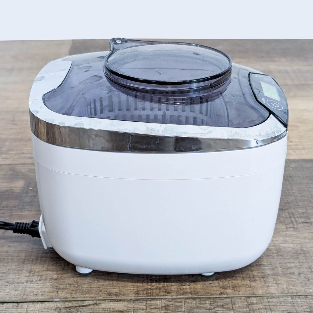 3. Side view of iSonic ultrasonic cleaner showing its compact size and translucent lid, designed for deep cleaning small items.