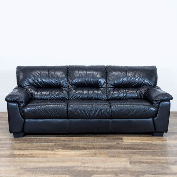 1. Ashley 3-seat sofa with plush cushioning and black leather upholstery, shown from the front on wooden flooring.