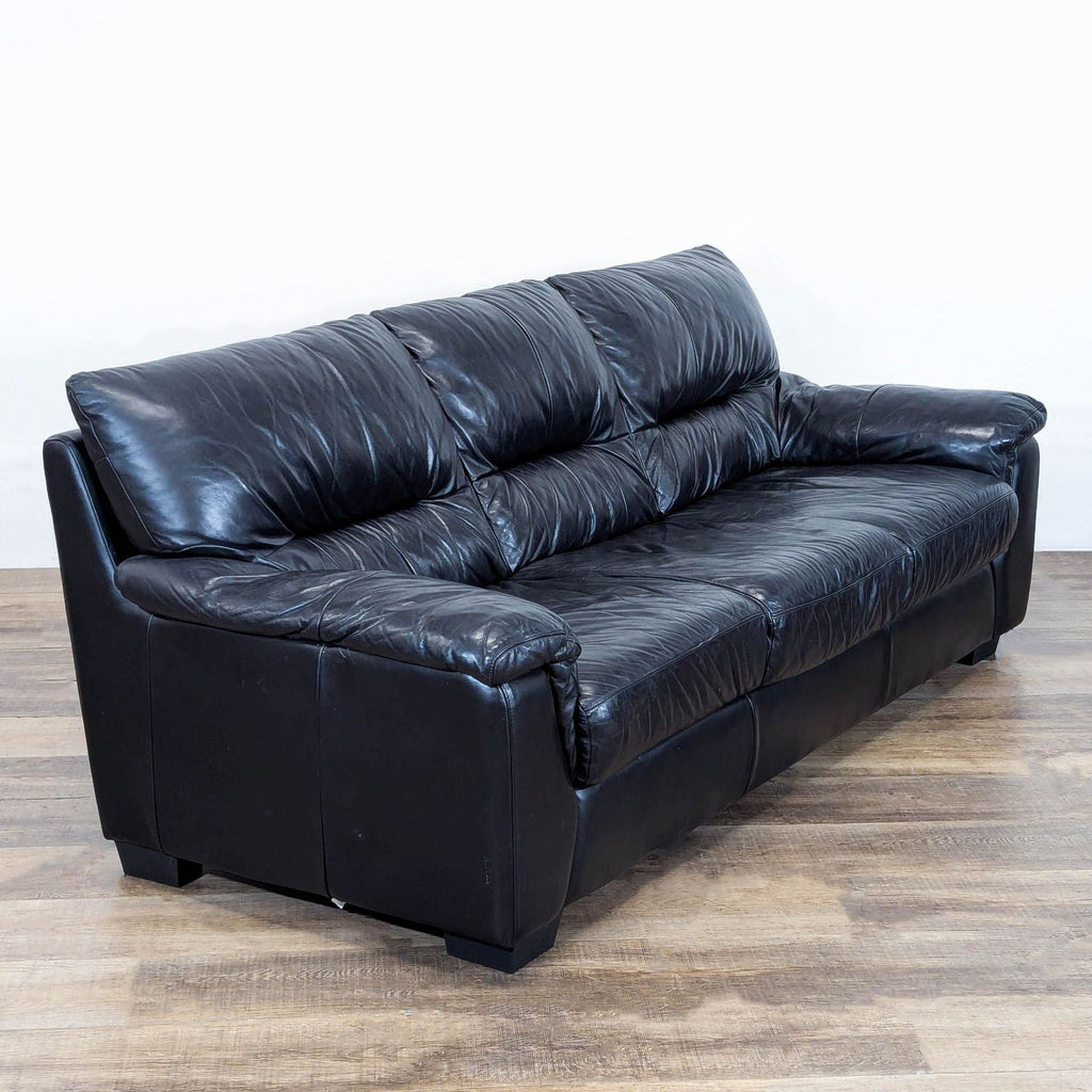3. Angled view of Ashley black leather 3-seat sofa, highlighting its plush design and modern look.
