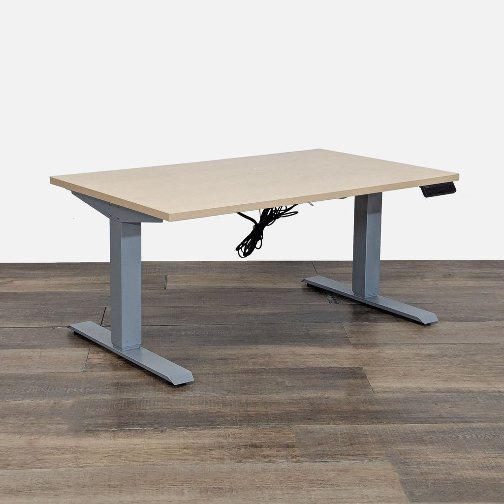 1. Adjustable height desk by Tüv Rheinland, features a light wood top and programmable control panel.  