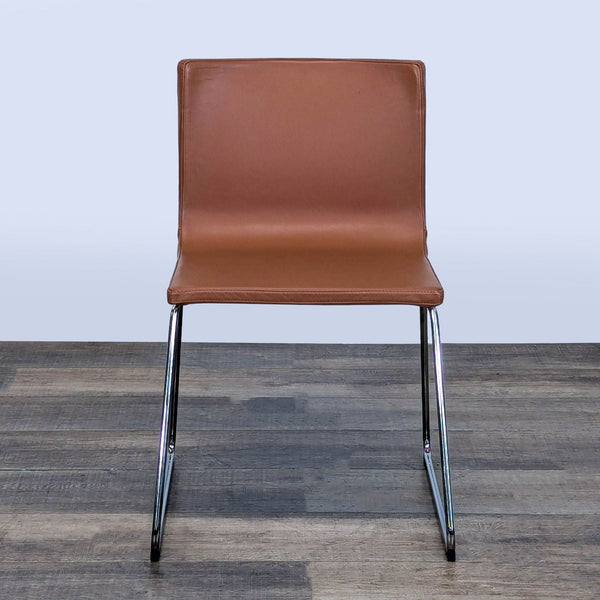 1. Front view of the Ikea Bernhard dining chair with chrome-plated legs and padded leather seat.
